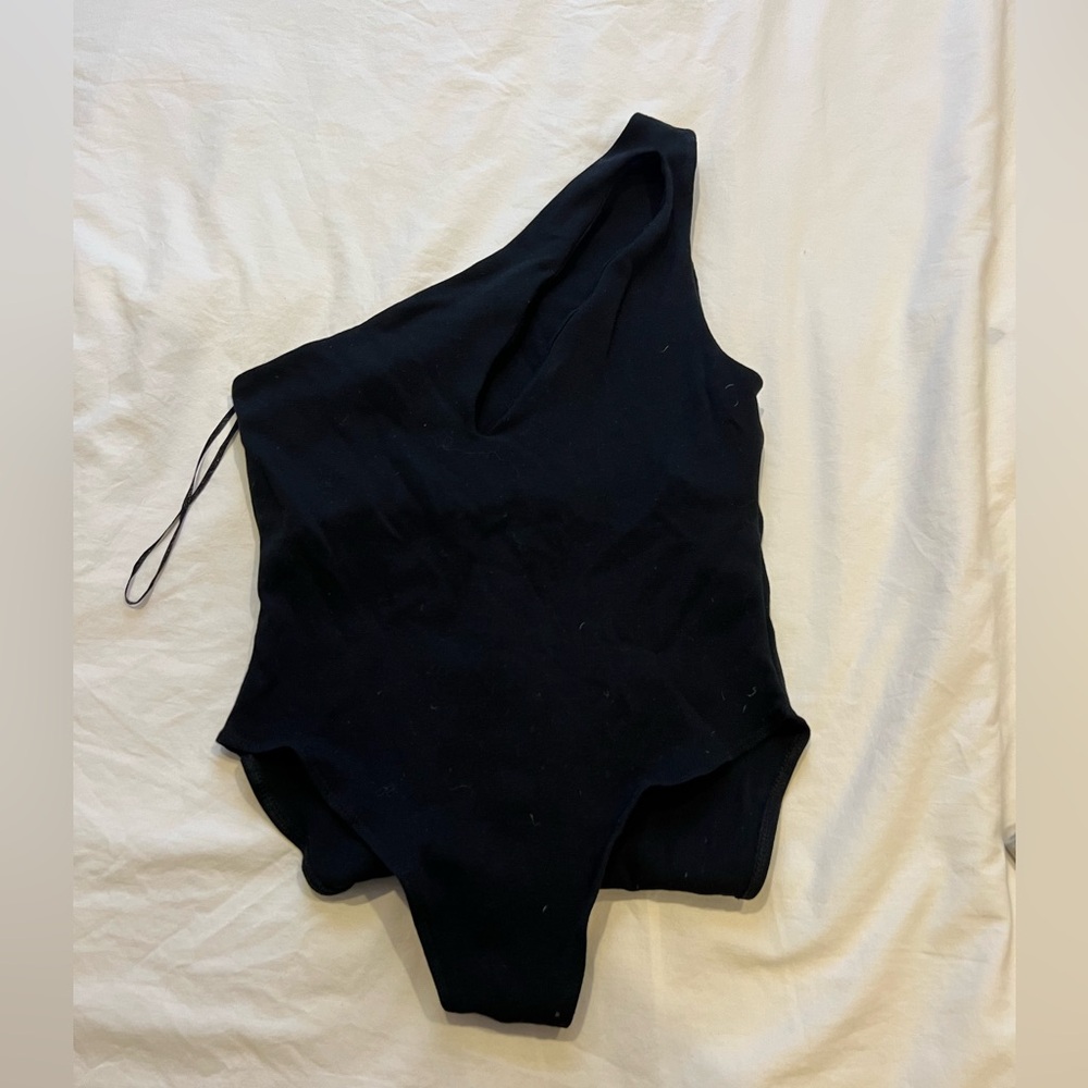 One-shoulder black bodysuit with slit